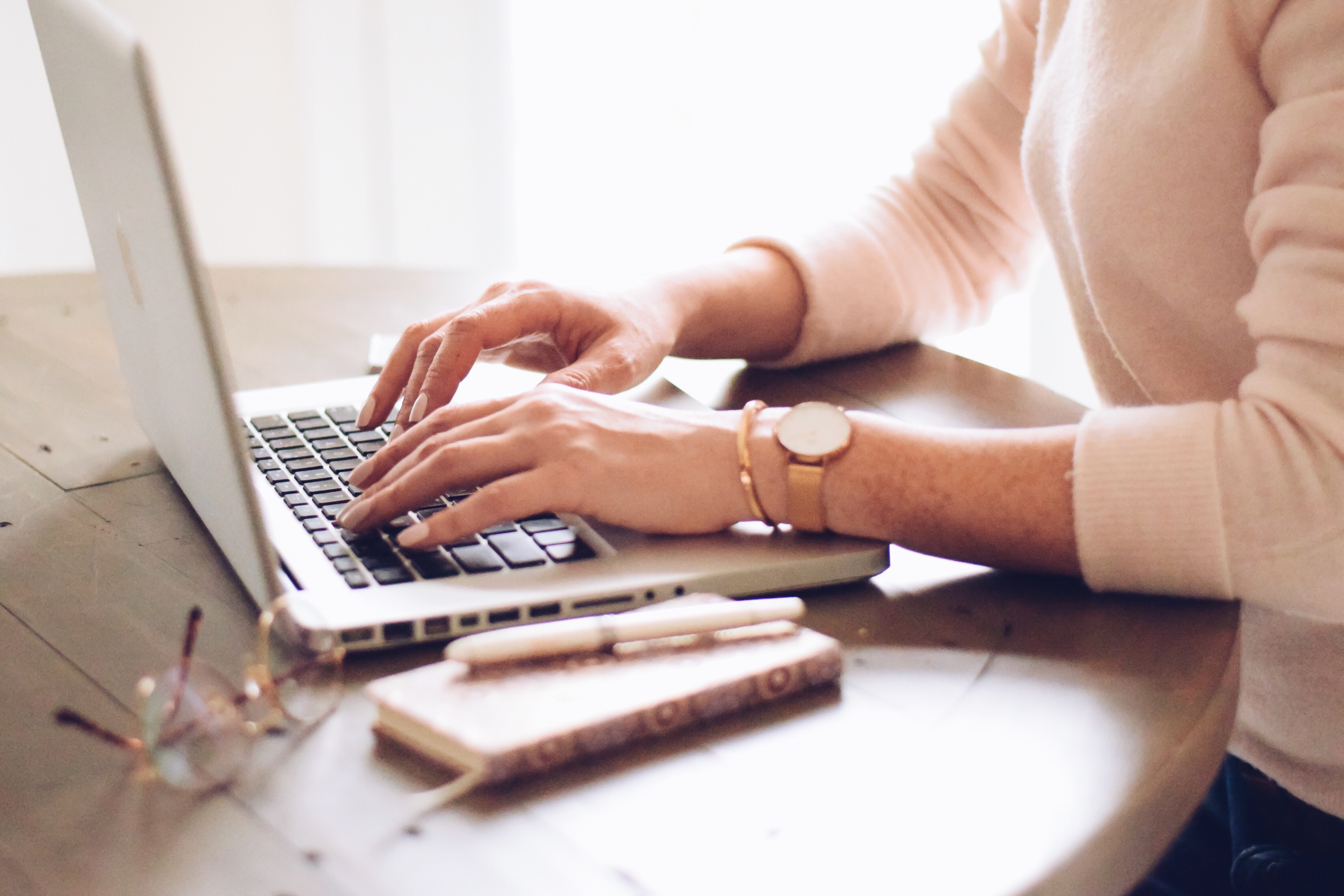 woman typing on laptop