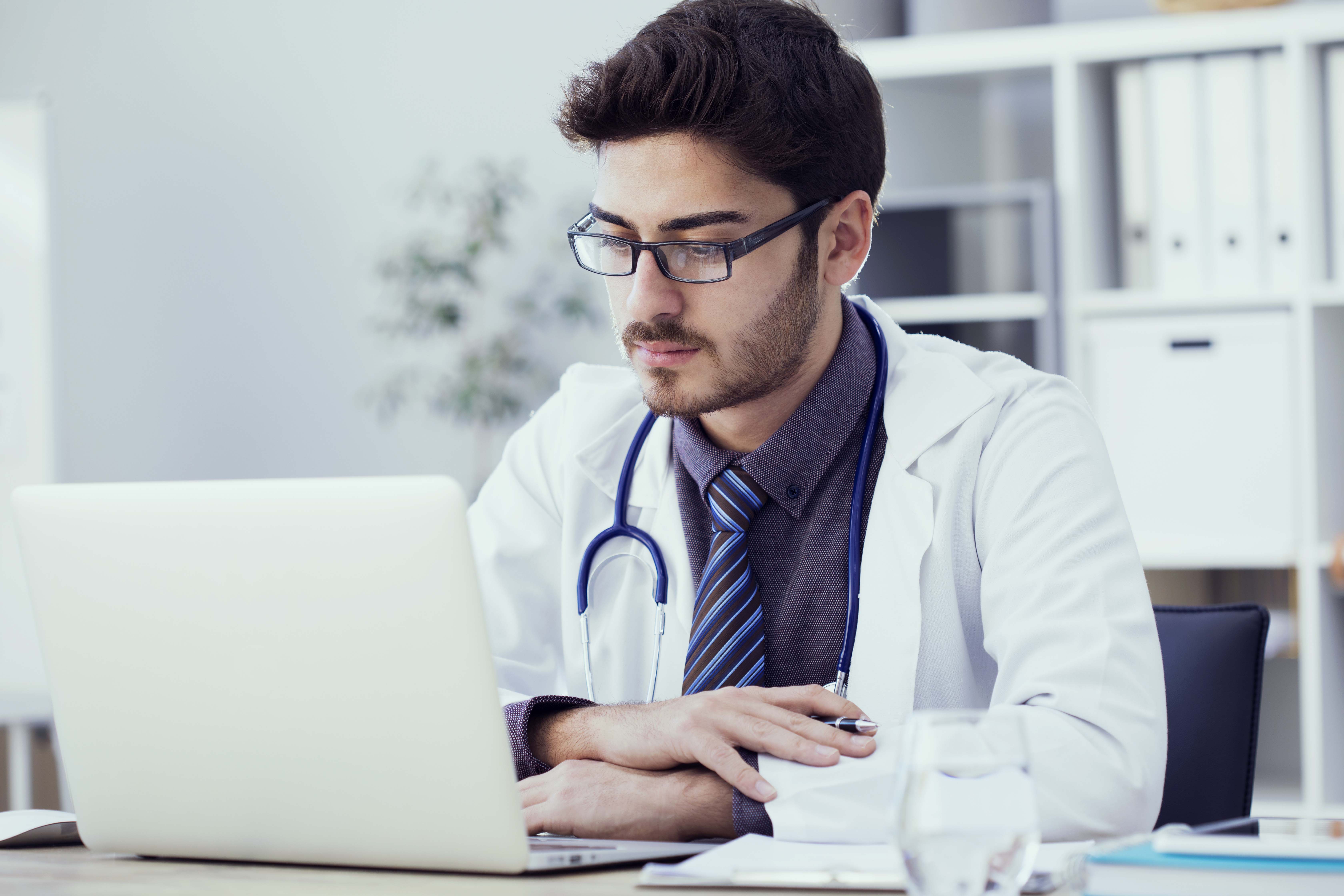 Portrait of doctor working on computer in medical office