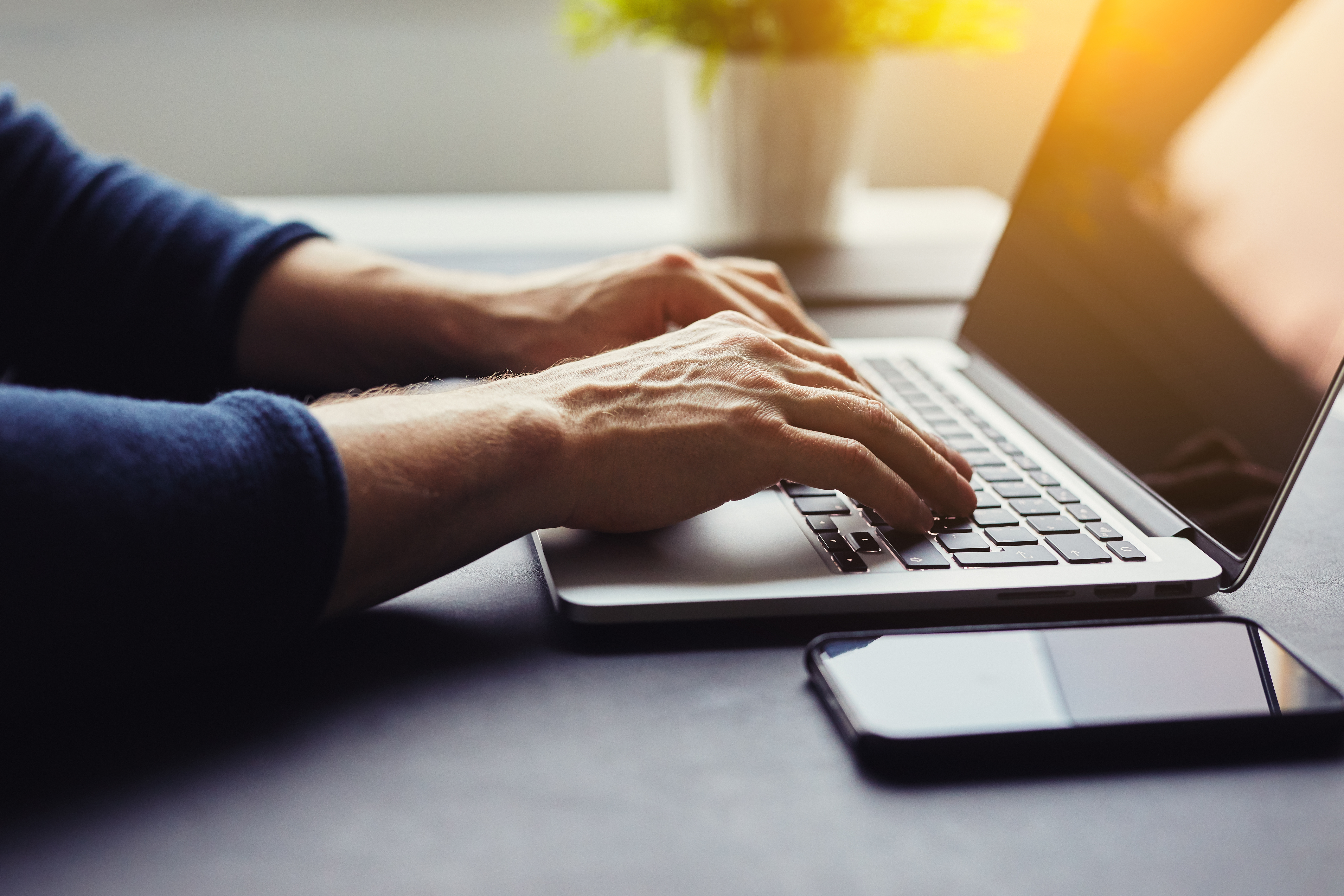 Man typing on laptop in the offic